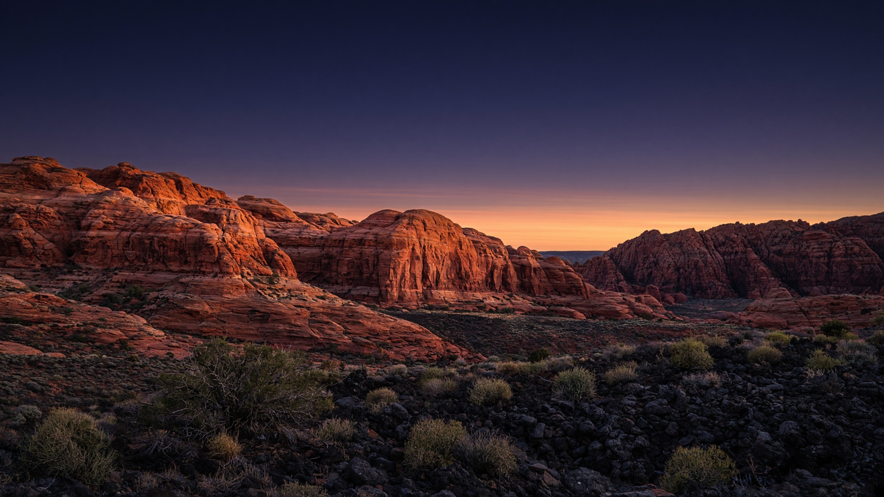 Snow Canyon at dusk, red cliffs under an indigo sky
